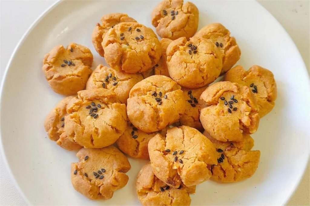 A platter of Hup Toh Soh Chinese walnut cookies, beautifully shaped and decorated, surrounded by festive decorations.